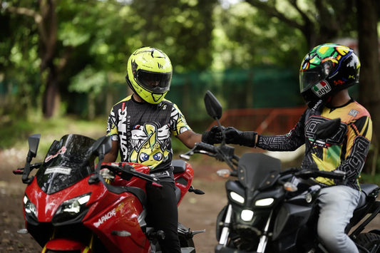 Two bikers fist bump wearing StreetSoul Racing jerseys on motorcycles in India